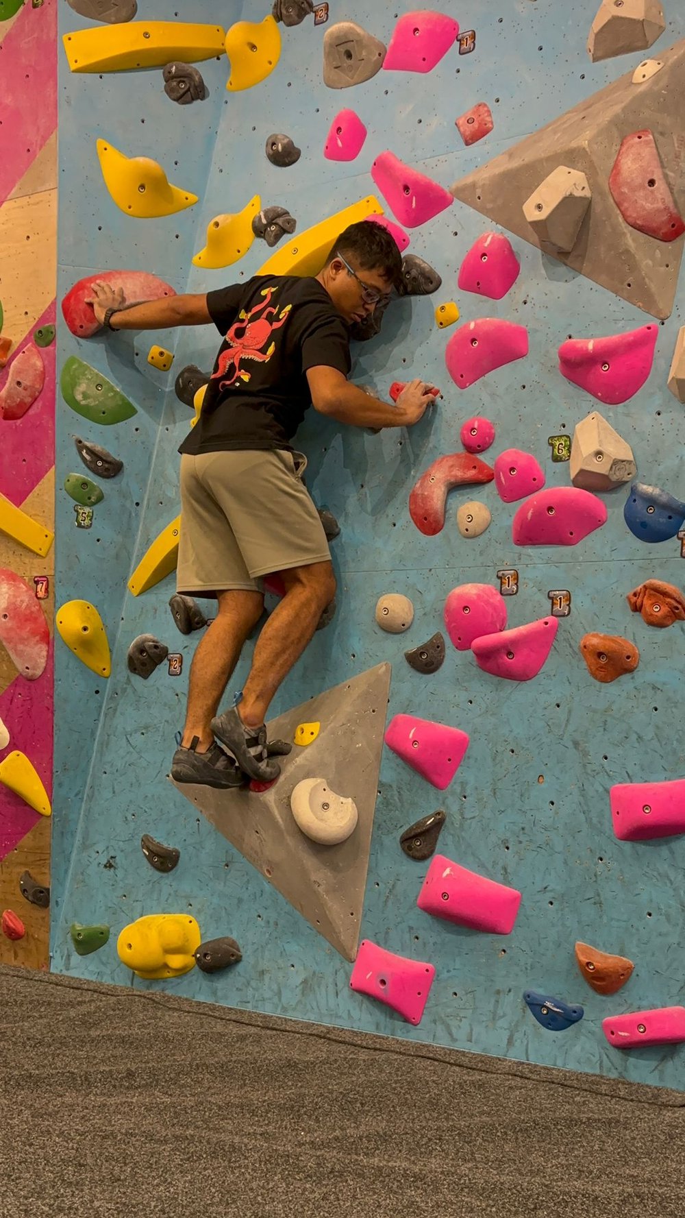 Yazid bouldering on an indoor climbing wall